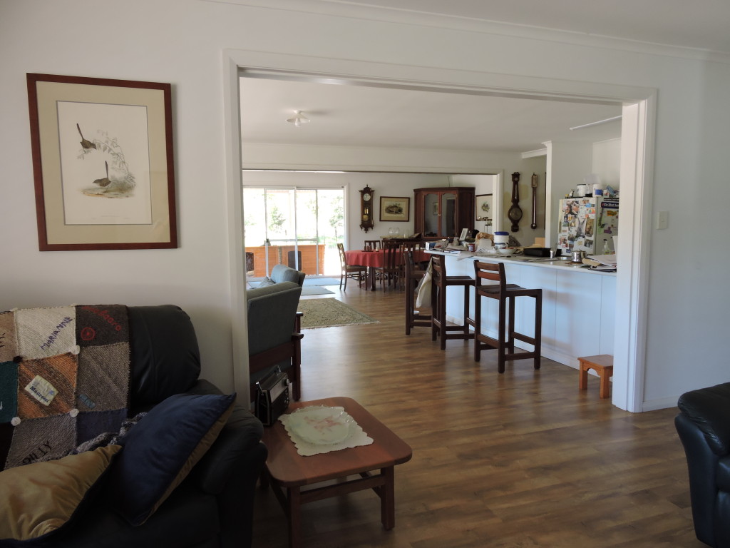 "before" view from TV room thru kitchen/family area to dining room